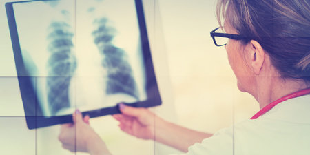 Female doctor looking at x-ray in clinic, geometric pattern