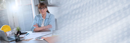 Portrait of middle aged female architect looking at the camera; panoramic bannerの写真素材