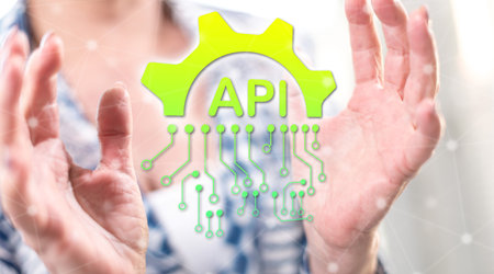 API concept between hands of a woman in background
