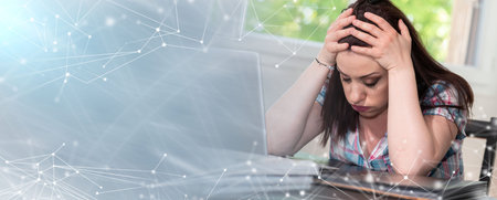 Overworked young businesswoman sitting in front of laptop; panoramic banner