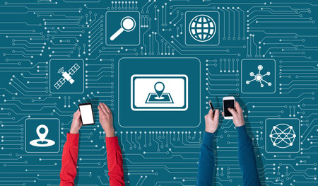 Top view of hands using mobile phone with symbol of gps concept