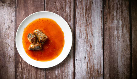 Canned fish in tomato sauce on wood background, Sardines, mackerel, Thai fast food and top view