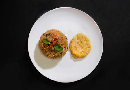 Basil pork fried rice and omelet egg on black background, Thai food, Street food, Image from the top viewの写真素材