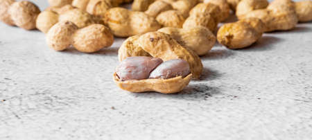 Peanut in a shell texture on white concrete background