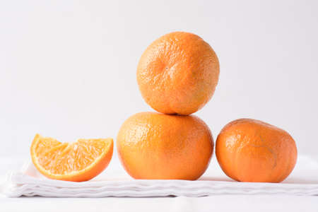 Fresh orange fruit on white backgroundの写真素材
