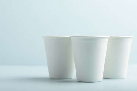 Biodegradable paper cup on blue background. Eco-friendly sustainable products concept zero waste lifestyle. Minimalism simple and copy spaceの写真素材