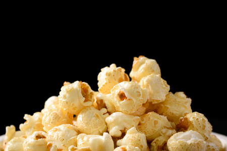 Close up of pile caramel popcorn on black backgroundの写真素材