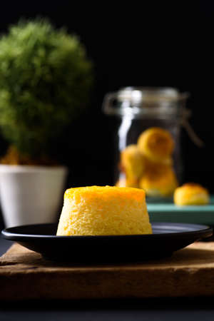 Gold egg yolk thread chiffon cake (Thai cake) on black plate