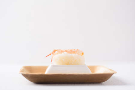 Nigiri sushi in a plate made from tree leaf on a white background is a cultural food of Japan, Asia.の写真素材