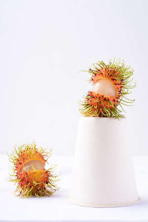 Fresh rambutan fruit with a paper cup on white background, Still life, Tropical fruitの写真素材