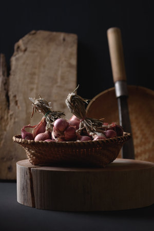 Shallots in a bamboo basket on wooden, Food ingredients in Thai cuisine, Still Lifeの写真素材