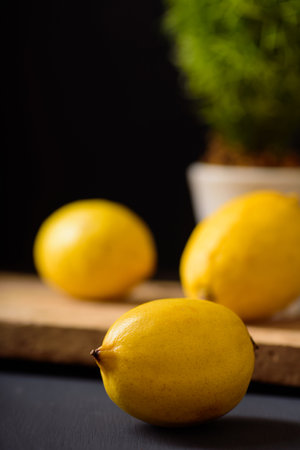 Ripe lemon fruit on black background, tropical fruit refreshing and healthy eating sour sweet tasteの写真素材