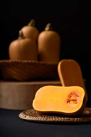 Butternut squash on black background, vegetable ingredient for healthy food in autumn and fall seasonの写真素材