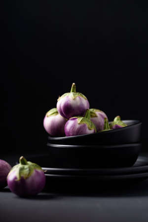 Natural organic fresh eggplant as food ingredients and healthy vegetarian food on black backgroundの写真素材