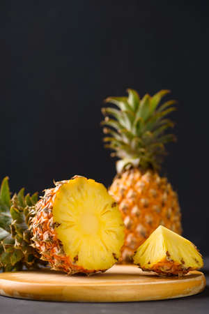 Pineapple from local market on black background, summer vacation beach idea