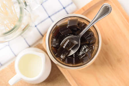 Grass jelly dessert with milk on white background, Traditional sweets that are cultural heritage of...