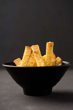 Garlic roasted bread stick on black background, a popular Asian snack foodの写真素材