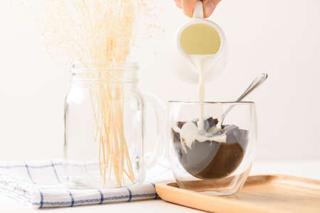 Grass jelly dessert with milk on white background, Traditional sweets that are cultural heritage of...
