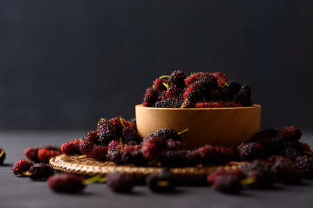 Mulberry fruit from local market on black background, Tropical fruit in spring and summer season