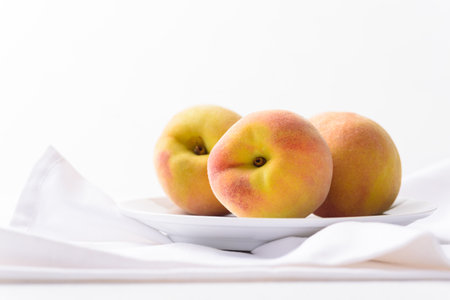 Fresh peach fruit on white backgroundの写真素材