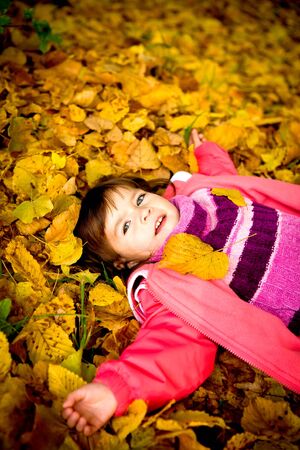 portrait of a little girl in the autumn parkの写真素材