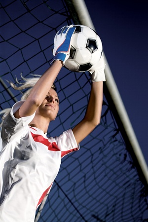 goalkeepers hands holding a soccer ballの写真素材