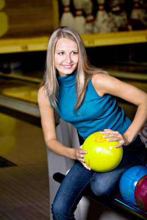 a young woman playing bowlingの写真素材