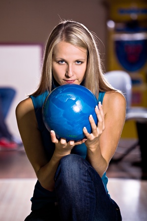 a young woman playing bowlingの写真素材