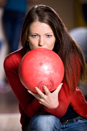 a young woman playing bowlingの写真素材