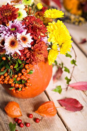 autumn flowers in front of the tableの写真素材