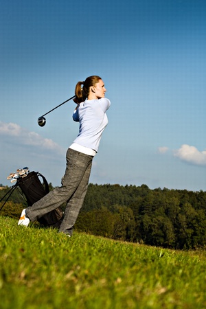 female golf player with a golf clubの写真素材