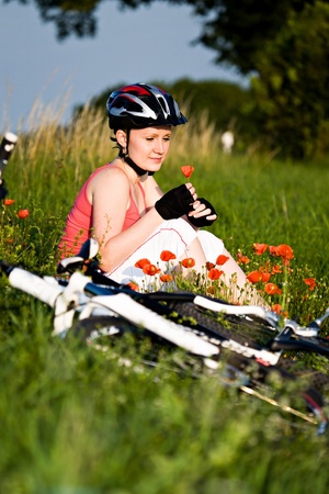 A cycling woman in front of rural landscapeの写真素材
