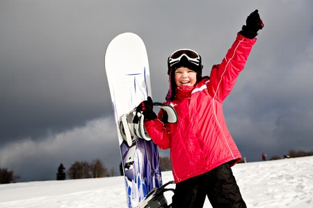 A young girl snowboarding in the Alps, outdoor shoot.の写真素材