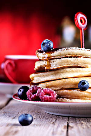 a plate with pancakes and raspberriesの写真素材