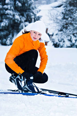 young woman cross-country skiing in a forestの写真素材