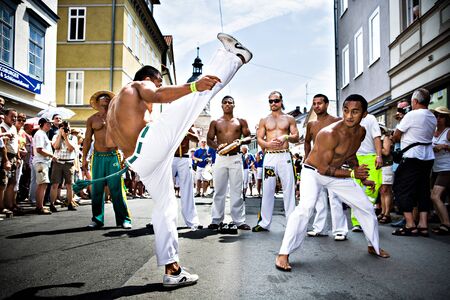COBURG, GERMANY - JULY 11: The unidentified male capoeira dancers participates at the annual samba festival in Coburg, Germany on July 11, 2010.のeditorial素材