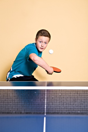 a boy playing table tennisの写真素材