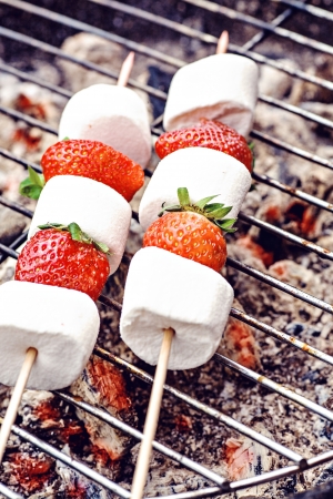 close up shut of marshmallows and stawberries on the grillの写真素材
