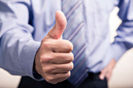 a businessman stick one's thumb in the air