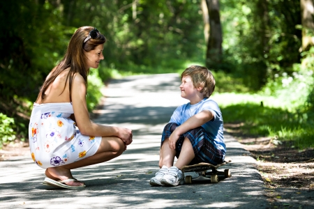 6-year-old boy with a scateboard on the parkwayの写真素材