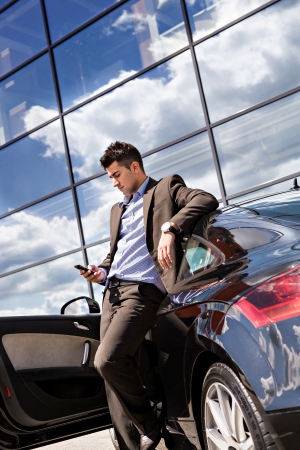 young businessman phoning at  a modern carの写真素材