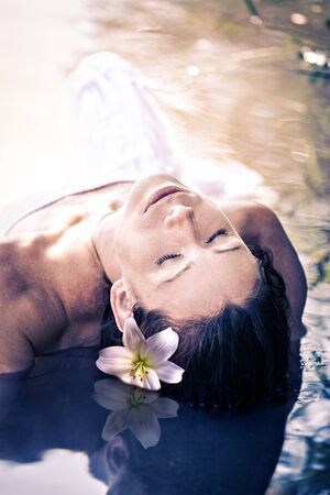 an outdoor portrait of a young woman in the waterの写真素材