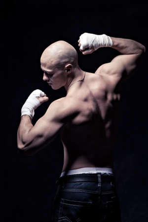 portrait of a young boxer in front of dark backgroundの写真素材