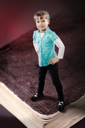 portrait of a little girl on a giant bookの写真素材