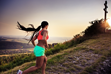 a young woman running in the mountains a young woman running in the mountains