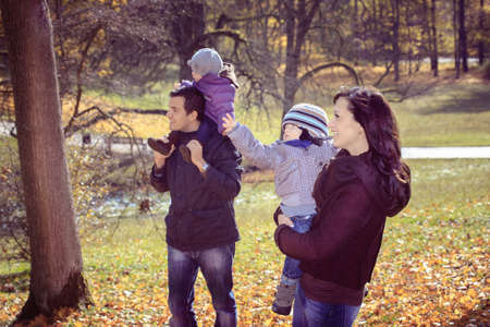 portrait of a young family in the autumn parkの写真素材