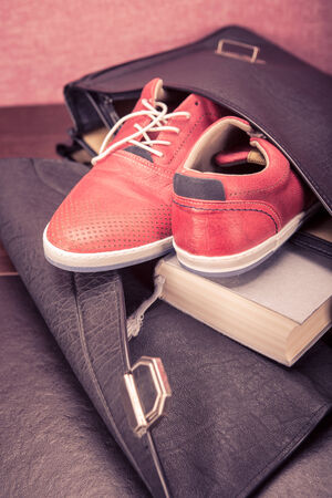 Close up shut of a pair  sneakers in a briefcaseの写真素材