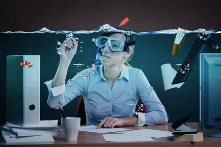 symbolic picture of a stressed female office worker and for stress at workの写真素材