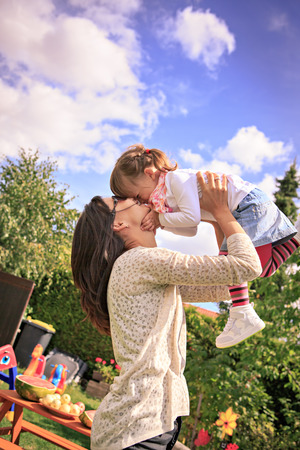 young mother with daughter in the backyardの写真素材