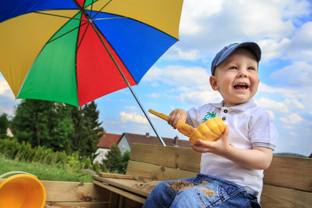 little male child playing in the sandboxの写真素材